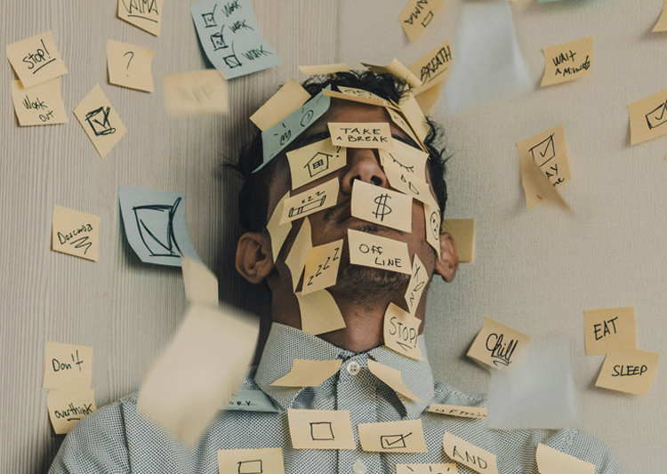 A person covered in post it notes with checklists