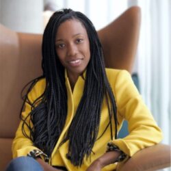 Babou Olengha-Aaby sitting in a chair and smiling